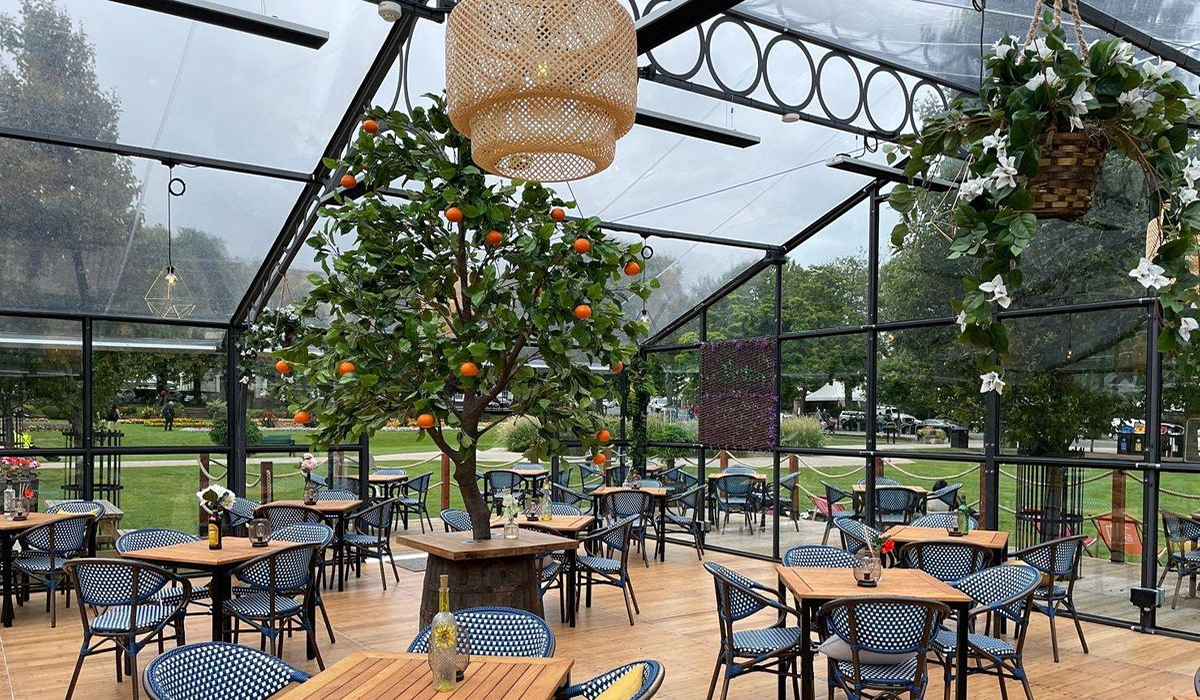 Covered glass outdoor cafe with heaters