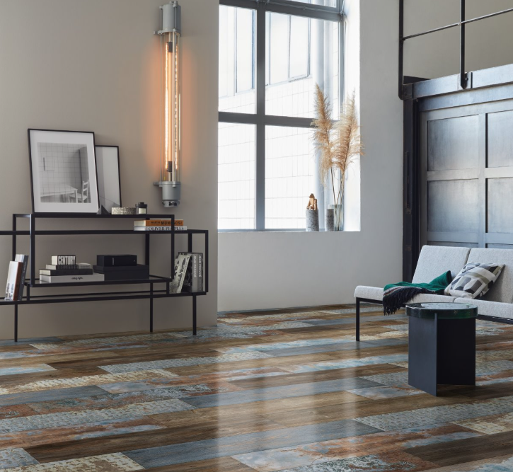 Modern living room with wooden flooring, a sofa, and decorative elements.