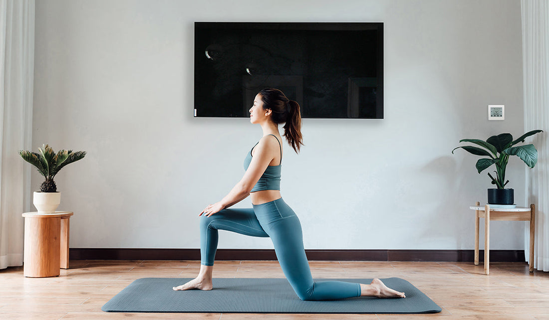 Lady exercising under infrared heating panel in UK home for improved air quality and respiratory health