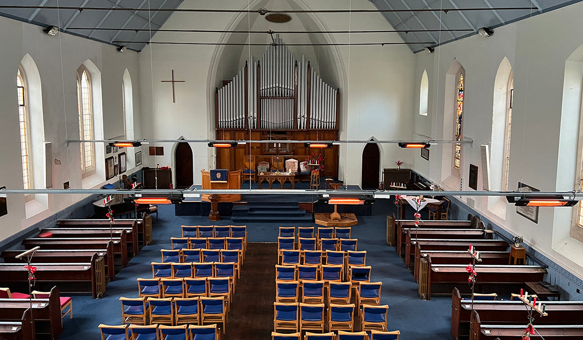 Church interior with ceiling-mounted infrared heaters for efficient space heating