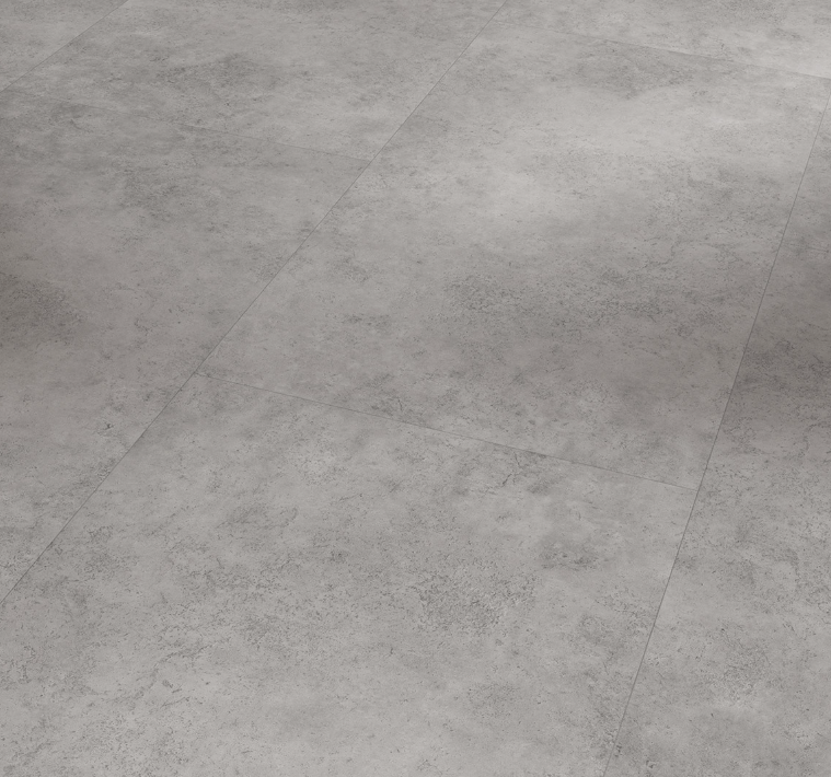 Large-format grey vinyl flooring with a mineral texture and 4-sided bevel. Available in glue and click version 