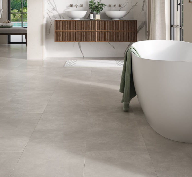 Modern bathroom with a freestanding bathtub and tiled floor.
