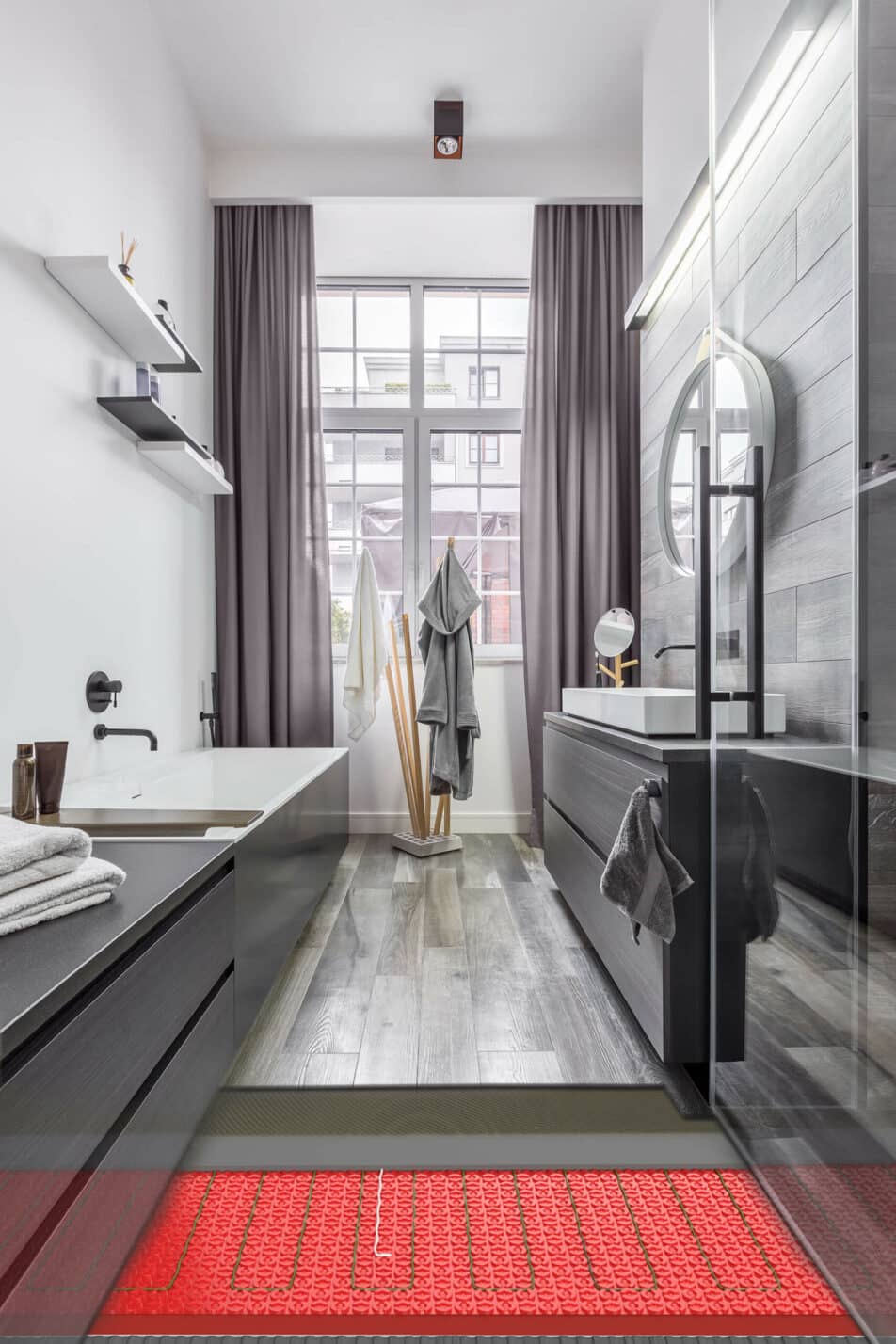 Cut out showing underfloor heating in a modern bathroom with gray cabinets, a red rug, and large windows.