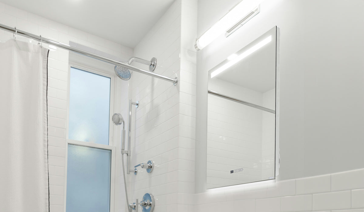 Eco-Friendly-Bathroom-heated-mirror-and-lights all in a white bathroom with white tiles
