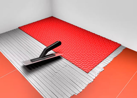 Underfloor heating DCM Fleece backing or Peel and Stick. Red tile leveling system with a trowel on a gray background