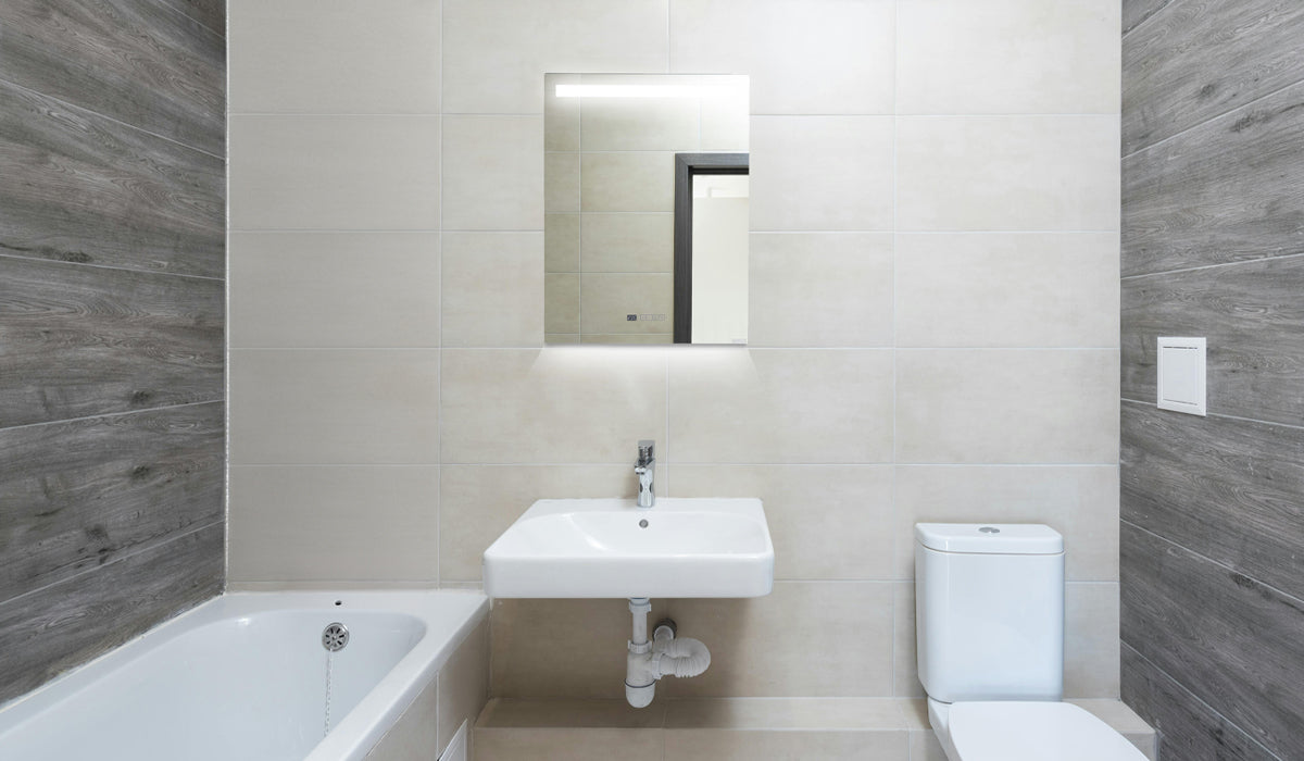 Eco-Friendly-Modern-Mirrored-Bathroom-Heater in a modern bathroom with beige and grey tiles.