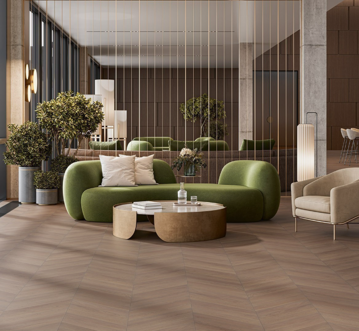 Modern interior with a green sofa, beige armchair, and wooden coffee table.