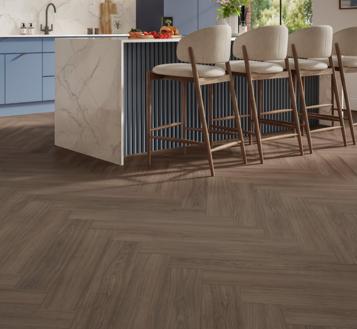 Wooden flooring with a kitchen and bar stools in the background