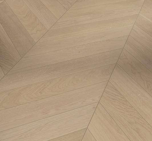 Close-up of a wooden floor with a chevron pattern