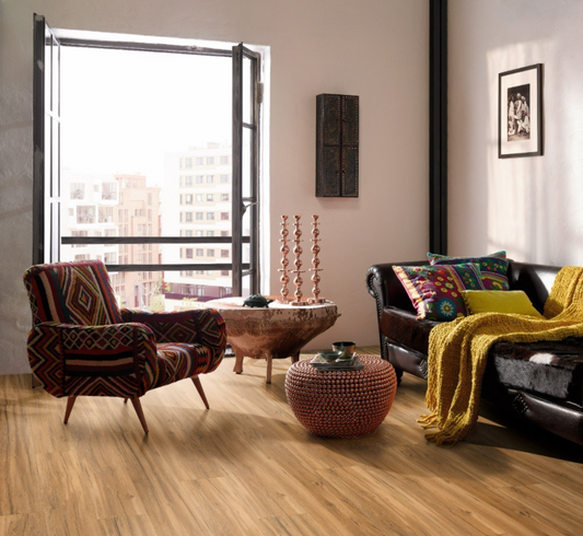 Modern living room with a large window, colorful furniture, and decorative items and oak memory natural wide plank flooring