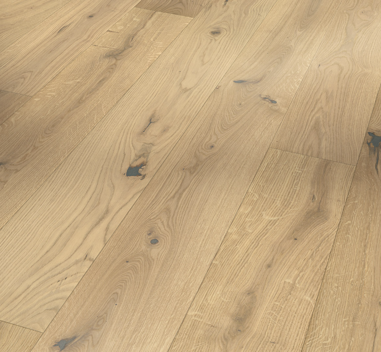Close-up image of wide plank engineered wood flooring with a natural oil plus finish.