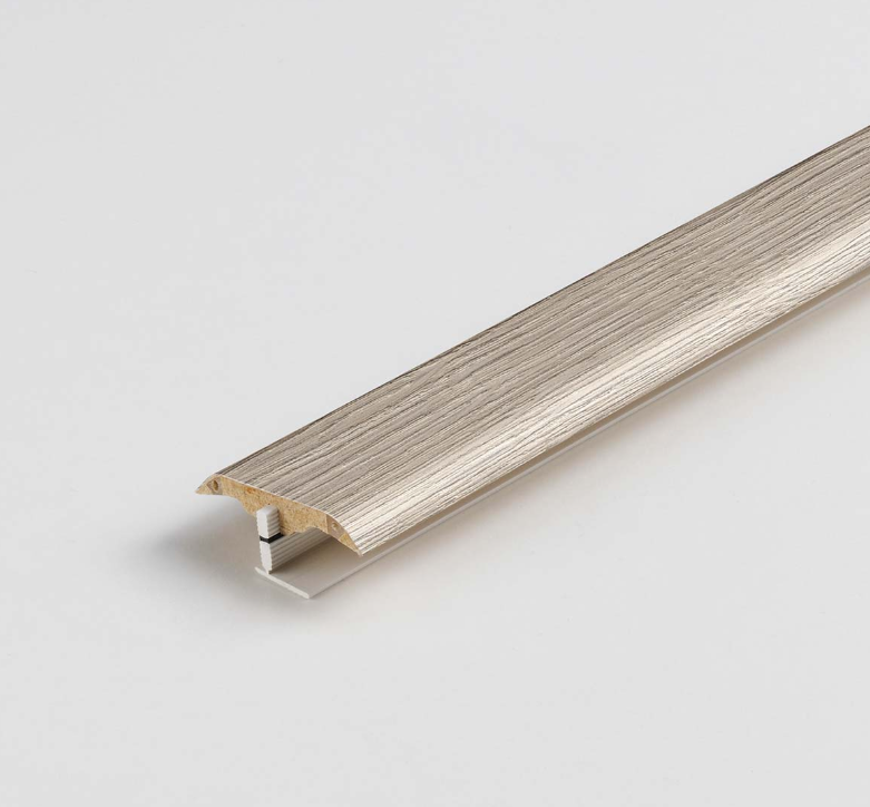 Wooden strip PROFILE in pearl grey with clip on a light gray background. Matches laminate floor. 