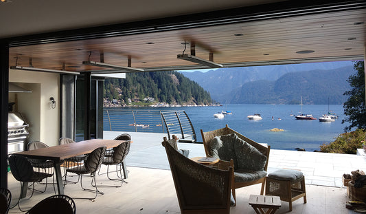 View of lake and boats with outside seating area and summit heaters