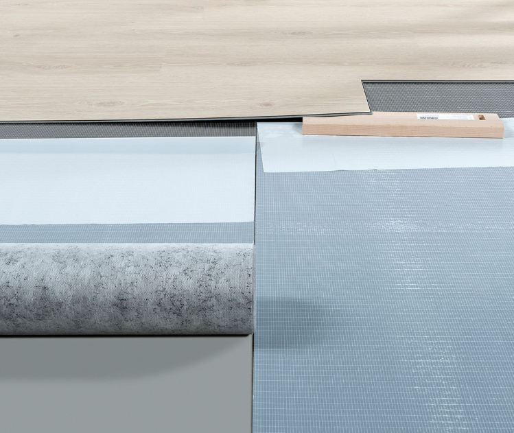 Roll of stick protect rolled out under a dryback beech coloured floor