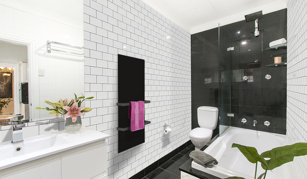 Black infrared towel heater with a pink towel and a large bath and mirror