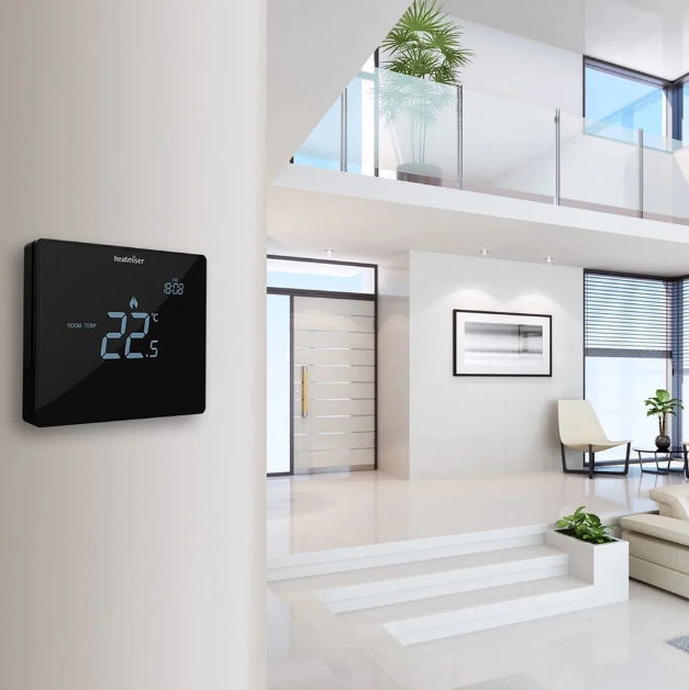 Digital thermostat on a wall in a modern living room