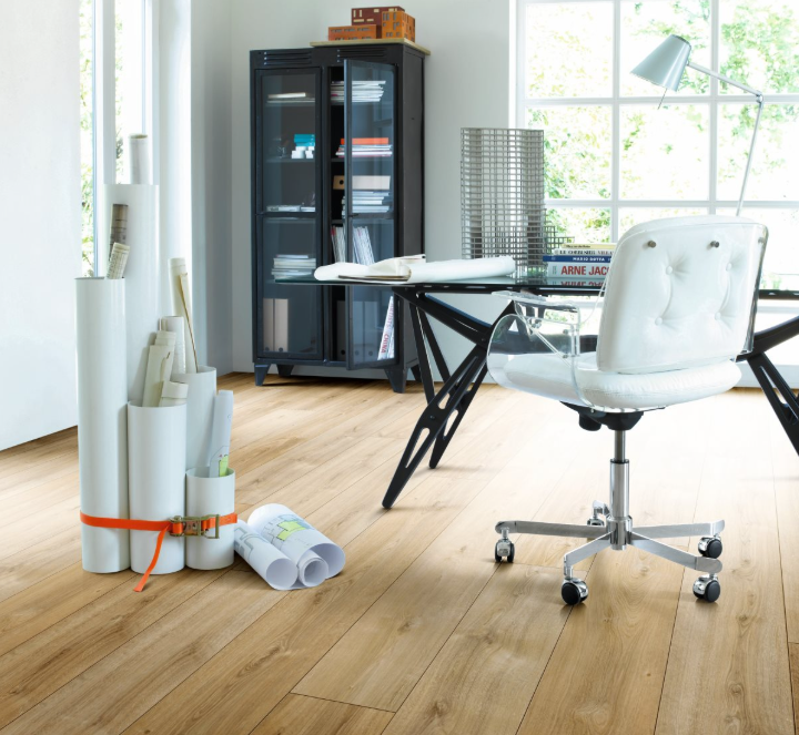 Modern office space with a glass desk and white chair on a wooden laminate floor from Parador