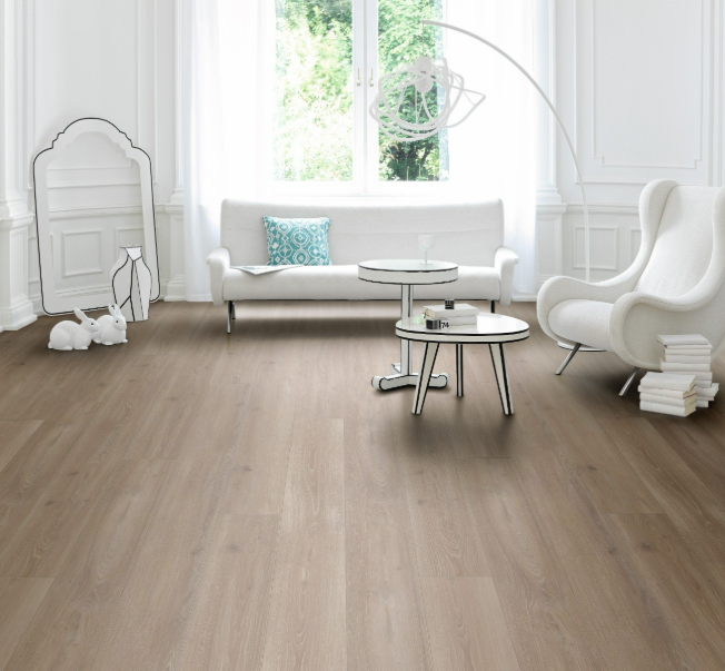Extra-long Parador Oak Skyline Pearl-Grey laminate flooring in a modern living room with wooden flooring, white furniture, and large windows.  