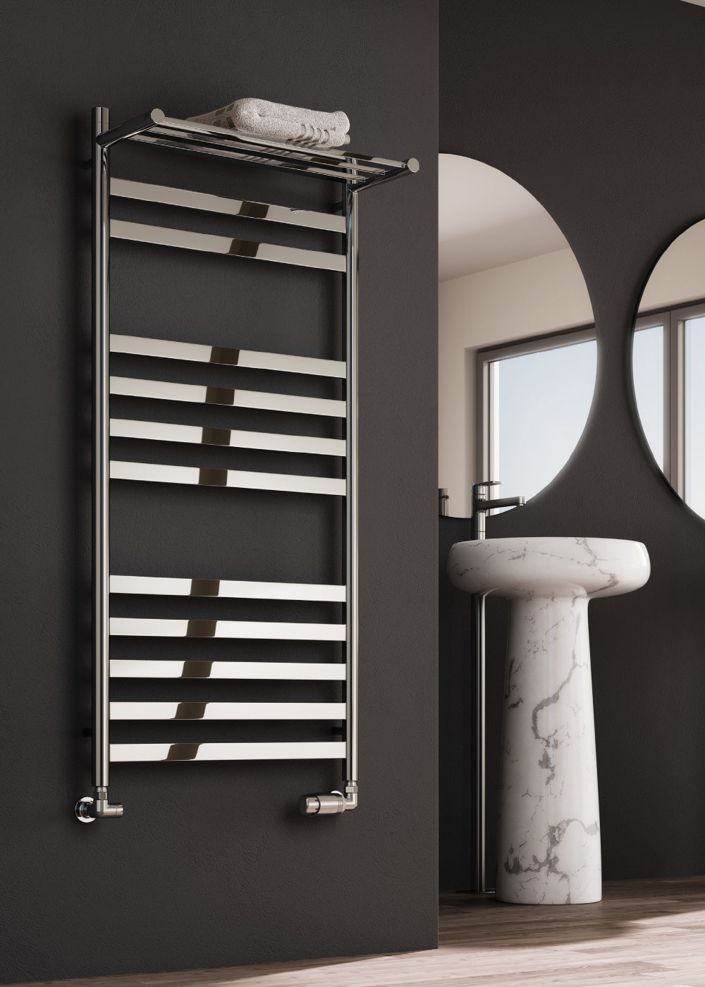 Towel radiator on a dark wall with a marble sink in a bathroom setting