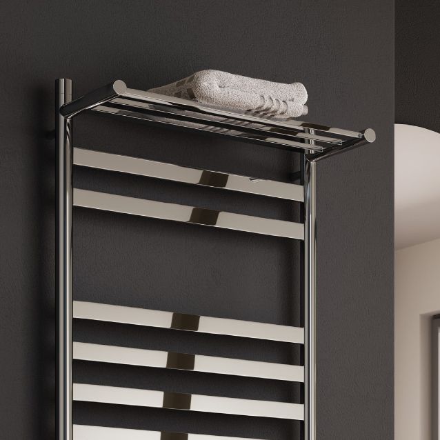Chrome towel rack with a white towel on a dark wall