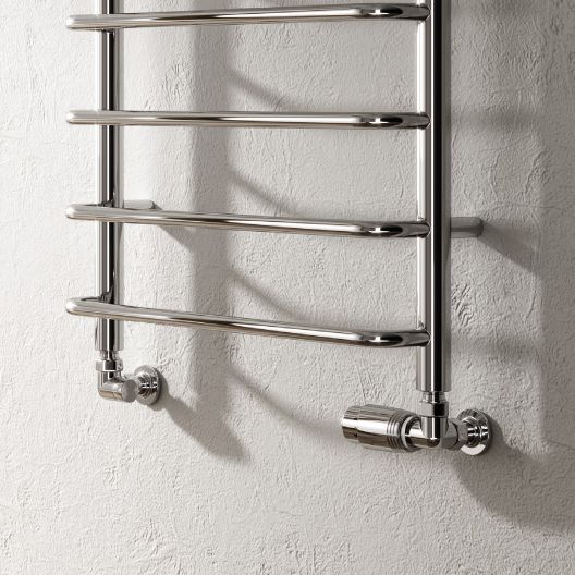 Chrome towel radiator mounted on a white wall